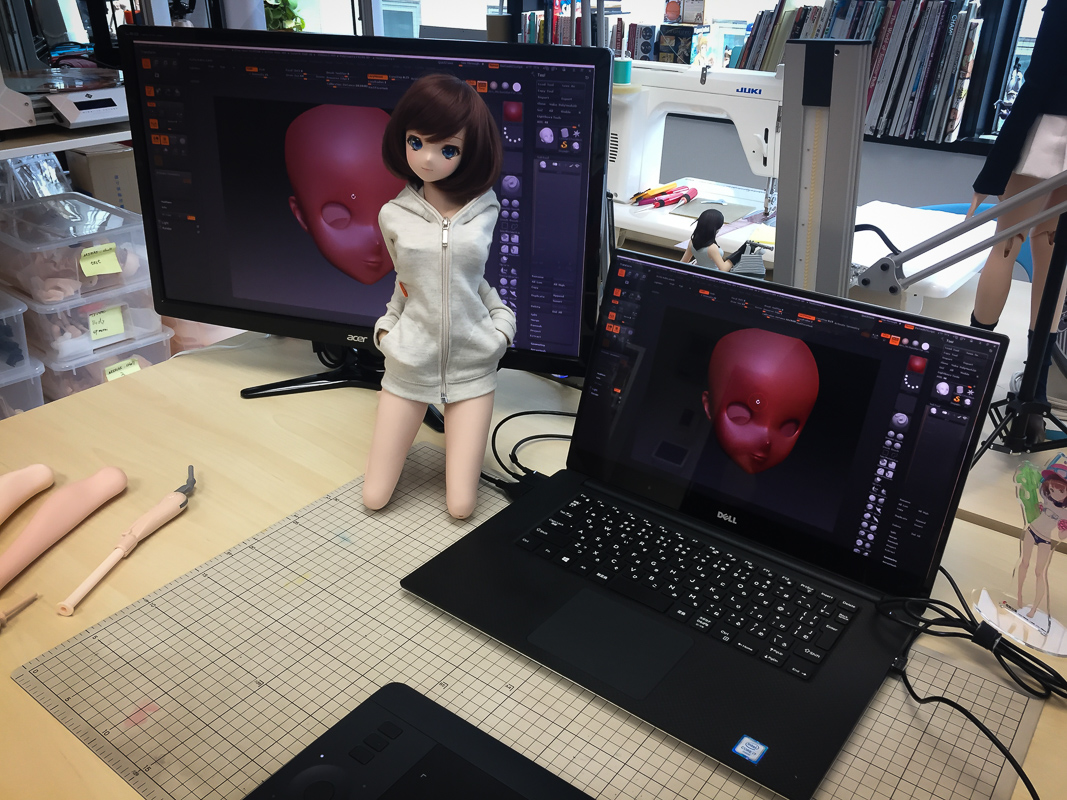 one of the SmartDolls next to her ZBrush model